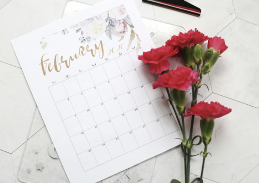 Couple relaxing together with a calendar nearby, representing scheduling time for intimacy and connection