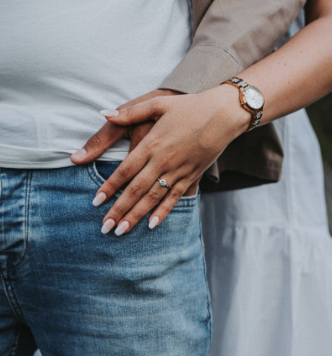 Couple sitting close together on a couch having a calm, connected conversation using EFT in couples therapy